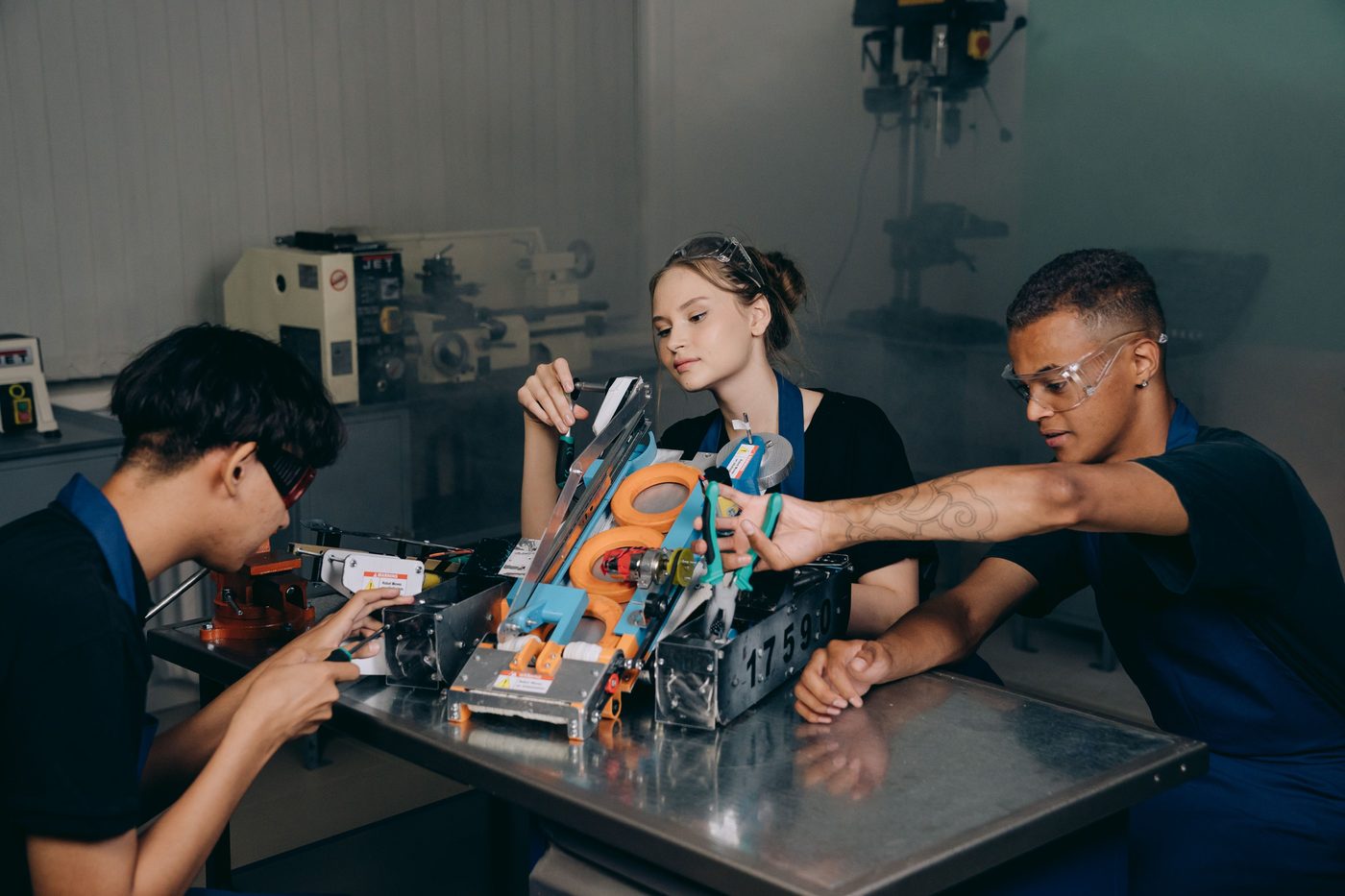 Students assembling robotics and drone hardware